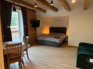 a bedroom with a bed and a table in a room at Nõmme Apartments in Tallinn