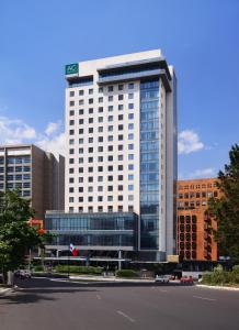 a tall white building with a lot of windows at AC Hotel by Marriott Santa Fe in Mexico City