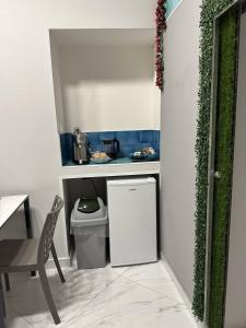 a small kitchen with a small refrigerator and a table at Vi Luxury Room in Pagani +24 photos