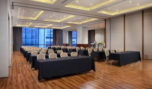 a conference room with rows of tables and chairs at AC Hotel by Marriott Santa Fe in Mexico City