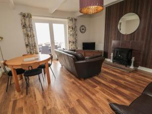 a living room with a couch and a table at Seaview Howick in Craster