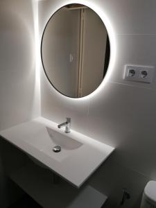 a bathroom with a white sink and a mirror at Apartamentos Argonavis in L'Estartit