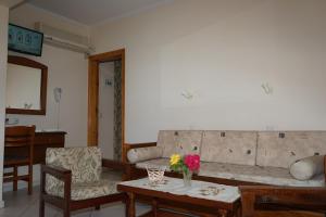 a living room with a couch and a table at Manos in Megás Limniónas