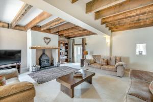 a living room filled with furniture and a fireplace at Stubbs Grange Barn in Fenwick