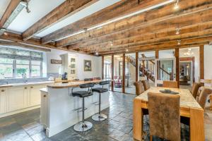 a kitchen with wooden ceilings and a table and chairs at Stubbs Grange Barn in Fenwick