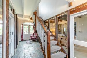 a hallway of a home with a staircase and a living room at Stubbs Grange Barn in Fenwick