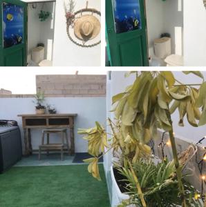 una habitación con una puerta verde y una mesa en My House Urban, en Arrecife