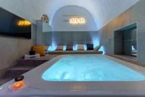 a large hot tub in a room with a tv at Anima Suite - Sauna - Jacuzzi e Cucina in Procida