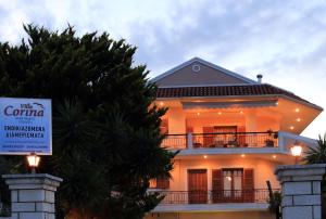 a white house with a sign in front of it at VILLA CORINA in Apolpaina
