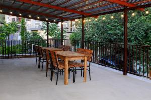 a wooden table and chairs on a patio at Kenut Hostel in Yerevan