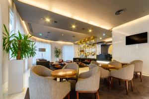 a hotel lobby with tables and chairs and a waiting room at Olissippo Saldanha in Lisbon