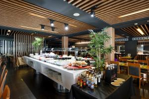 a buffet table in a restaurant with food on it at Flash Hotel Benidorm - Recommended Adults Only 4 Sup in Benidorm