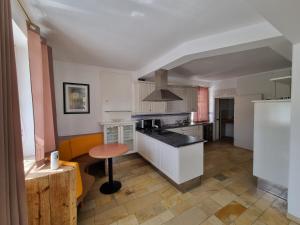 a kitchen with white cabinets and a counter top at Villa Theresa in Hofstetten