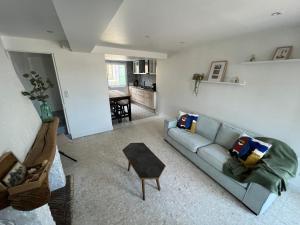 a living room with a couch and a table at Location de maison Au fil de l O la Bouille in La Bouille +19 photos