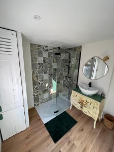 a bathroom with a sink and a mirror at Location de maison Au fil de l O la Bouille in La Bouille