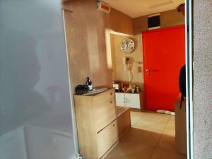 a small kitchen with a red door and a red cabinet at Dorobantilor House in Cluj-Napoca