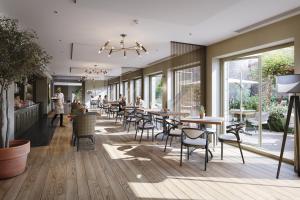 un restaurant avec des tables et des chaises et des personnes se promenant dans les environs dans l'établissement Bailiffgate Hotel, à Alnwick