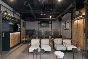 a restaurant with chairs and tables and a tv at 9 apartments in Jagodina