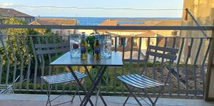 a table and two chairs on a balcony at Alba Marina e Tramonti Etnei in Riposto