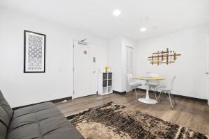 a living room with a table and chairs at Sunset Inn-South Miami in South Miami