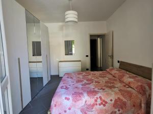 a bedroom with a large bed with a pink blanket at Da Paolino, tra mare e vino in Viareggio