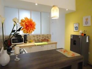 a kitchen with a refrigerator and a table in it at Casa Marbella in Huancayo