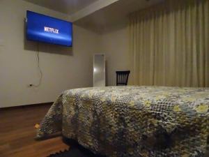a hotel room with a bed and a sign on the wall at Casa Marbella in Huancayo