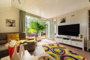 a living room with a large flat screen tv at Feriendomizil Tippe in Braunlage