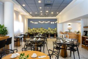 a dining room filled with tables and chairs at Maxim Design Hotel 3 Star Superior in Tel Aviv