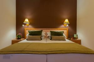 a bedroom with a large bed with green pillows at Apartments Dubrovnik Lapad in Dubrovnik