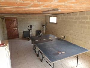 a ping pong table in a room with a wall at Beatitude62 in Fauquembergues