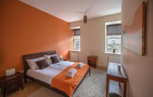 a bedroom with a bed and two windows at Cloister View in Fort Augustus