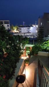 a balcony with a bench and trees at night at Brb rooms in Himare