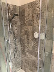 a shower in a bathroom with a glass door at Nontiscordardimé Apt in Torre a Mare