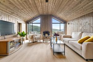 a living room with a couch and a television at Hodlekvevegen 307 in Sogndal