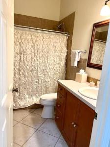 a bathroom with a toilet and a sink and a shower at BCC Country Club in Bradenton