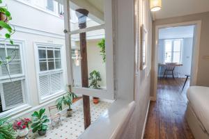 a living room with large windows and plants at Double Room, attached bathroom - Casa del Indiano in La Orotava