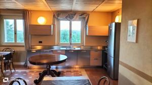 a kitchen with a table and a refrigerator at Florario B&B in Chieri