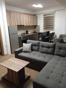 a living room with a couch and a kitchen at Eva apartment in Štip