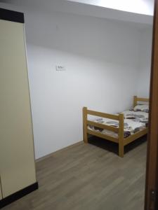 a small bedroom with a bed and a mirror at Eva apartment in Štip