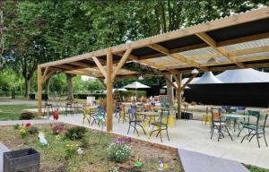 a group of tables and chairs under a pavilion at Attrayant studio tout équipé en Bord de Marne - Proche Disney in La Ferté-sous-Jouarre