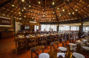 a dining room with tables and chairs in a building at Wyndham Garden Luján in Luján