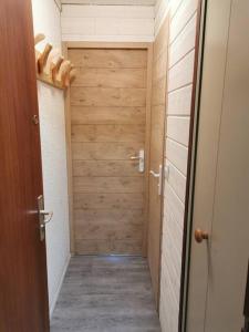 um corredor com uma porta de madeira num quarto em Duplex plein sud_skis aux pieds_Plagne villages em La Plagne Tarentaise