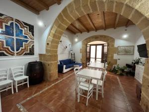 a living room with a table and chairs at Dimora Tipica in Marsala