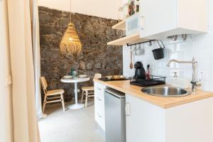a kitchen with a sink and a table at Studio Canario with patio - Casa del Indiano in La Orotava