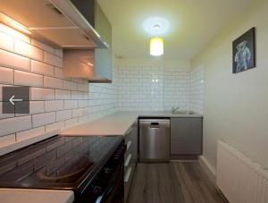 a kitchen with a sink and a counter top at 2 bedroom flat opposite Hyde Park & Royal Lancaster in London