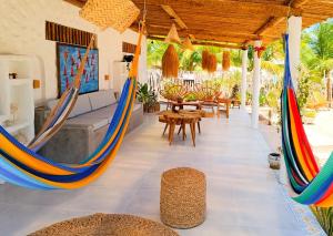 a room with hammocks in a house at Flats Macapá Meu Amor in Luis Correia