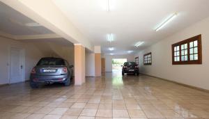 two cars parked in a room with a garage at VILLA CORINA in Apolpaina +134 photos