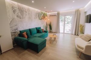a living room with a green couch and a table at Vallia Suites-Green Luxury Suite A3 in Nafpaktos