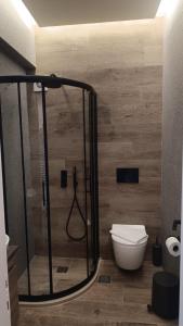 a bathroom with a shower and a toilet at Vallia Suites-Green Luxury Suite A3 in Nafpaktos